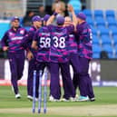 Scotlands Michael Leask (C) celebrates with teammates after dismissing West Indies captain Nicholas Pooran