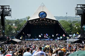 Crowds of festival-goers watch Tom Odell perform on the Pyramid Stage during day three of Glastonbury Festival 2019