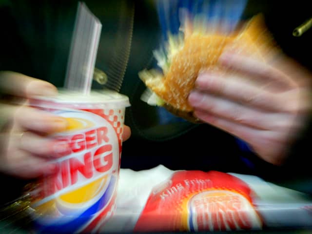  A man eats his lunch at a Burger King restaurant.