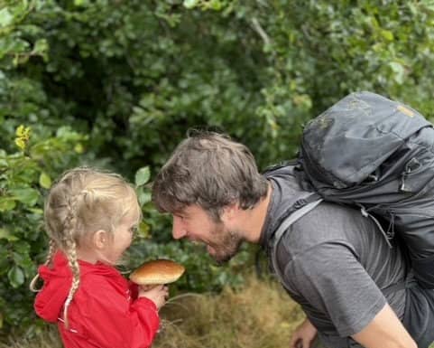 Jim Parums and his daugher foraging a mushroom - the family save £100 a week by foraging for all their meals. 