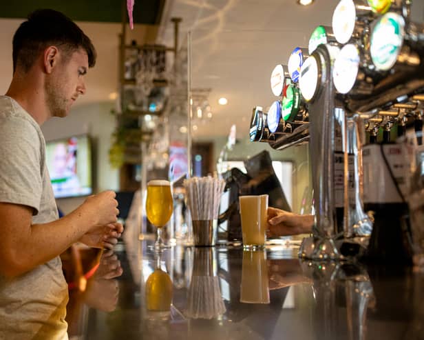 A customer buys a drink at a Wetherspoons pub in Clapham, London.