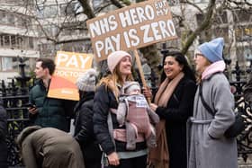 Demonstrators hold placards as they take part in a protest by junior doctors. Picture: NIKLAS HALLE’N/AFP via Getty Images