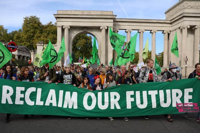 Protesters march into central London at a demonstration by the climate change protest group Extinction Rebellion, on October 16, 2022. Credit: Isabel Infantes/AFP.