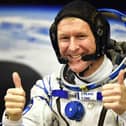 Britain's astronaut Tim Peake gestures as his space suit is tested at the Russian-leased Baikonur cosmodrome (photo: Getty Images)