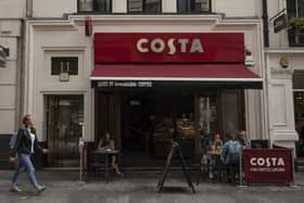 LONDON, ENGLAND - AUGUST 31: Customers sit outside a Costa Coffee store on August 31, 2018 in London, England. Coca-Cola Co. is to buy the U.K. chain Costa Coffee for £3.9 billion GBP, ($5.1 billion USD). (Photo by Dan Kitwood/Getty Images)