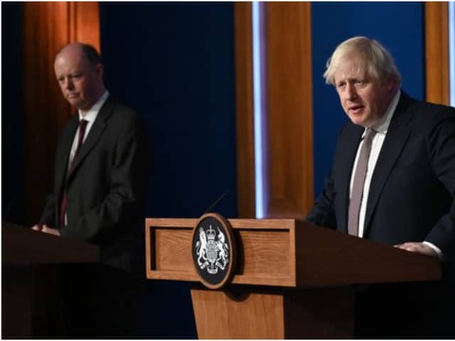 LONDON, ENGLAND - NOVEMBER 15: Prime Minister Boris Johnson standing next to British Chief Medical Officer for England Chris Whitty as he addresses the media regarding the United Kingdom's Covid-19 infection rate and vaccination campaign at Downing Street Briefing Room on November 15, 2021 in London, England. The prime minister and his advisers encouraged Britons to receive their Covid-19 vaccine booster when eligible. (Photo by Leon Neal - WPA Pool/Getty Images)