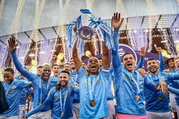 Fernandinho of Manchester City lifts the Premier League Trophy with team mates (Photo by Michael Regan/Getty Images)