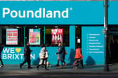 Shoppers walk past a Poundland shop in Brixton, south London.