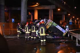 Firefighters work on the site of a bus accident on 3 October in Mestre, near Venice (Photo: MARCO SABADIN/AFP via Getty Images)