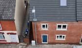 A builder in Ashton-under-Lyne built a house around a lamppost rather than wait for it to be moved. It will be moved at a later date 