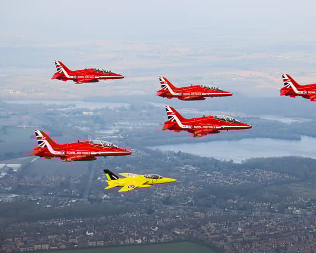 The Red Arrows fly alongside a Yellow Jack