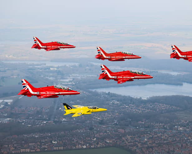 The Red Arrows fly alongside a Yellow Jack