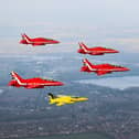 The Red Arrows fly alongside a Yellow Jack