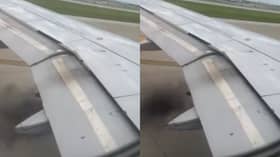 Plane’s engine catches fire as black smoke billows from wing.