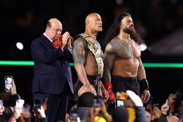 Paul Heyman, Dwayne "The Rock" Johnson and Roman Reigns look on following a fight against Cody Rhodes and Seth "Freakin" Rollins during Night One of WrestleMania 40 at Lincoln Financial Field on April 06, 2024 in Philadelphia, Pennsylvania.  (Photo by Tim Nwachukwu/Getty Images)
