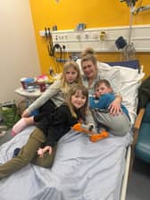 Lucy Woodhouse, 43, with her three children in hospital.