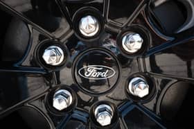The Ford logo is shown on the wheel of a car. (Photo by Scott Olson/Getty Images)