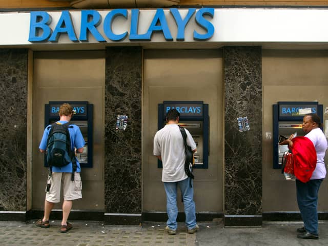 Commuters withdraw cash from ATMs outside a branch of Barclays Bank in London (Photo: Sion Touhig/Getty Images)