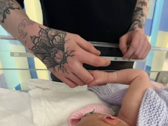 Baby Talia and father Euan. Anna Jackson, 22, started getting a pain in her abdomen, but had put it down to period cramps.  Picture: Anna Jackson/SWNS