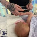 Baby Talia and father Euan. Anna Jackson, 22, started getting a pain in her abdomen, but had put it down to period cramps.  Picture: Anna Jackson/SWNS