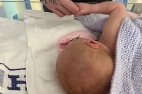 Baby Talia and father Euan. Anna Jackson, 22, started getting a pain in her abdomen, but had put it down to period cramps.  Picture: Anna Jackson/SWNS