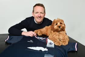Crunchy Carrots’ managing director Scott Henderson poses for a picture with valued staff member Arthur and Falkirk’s current home top adoring their carrot logo (Photo: Michael Gillen)