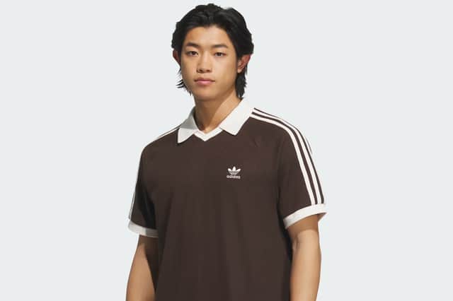 The waffle-textured polo adds a retro twist to the Oasis x Adidas range, blending sporty structure with casual summer style.