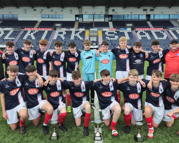 Falkirk Foundation's 2010 Blues' squad and coaching team pose with their league and cup trophies
