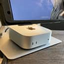 My Apple Mac mini M4 set up neatly under the monitor on my home office desk.
