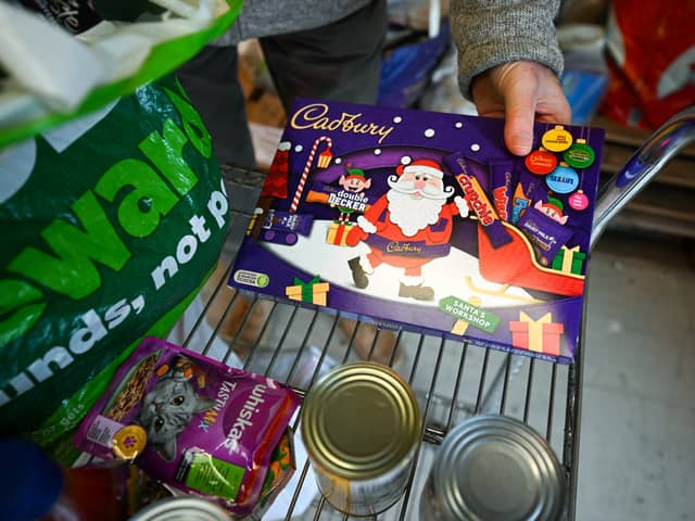 A Christmas chocolate selection box is unpacked in Weymouth Foodbank distribution hub in December 2023 (Photo: Finnbarr Webster/Getty Images)
