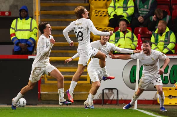 Ben Krauhaus wheels away to celebrate with his Falkirk team-mates after scoring the winner against Aberdeen