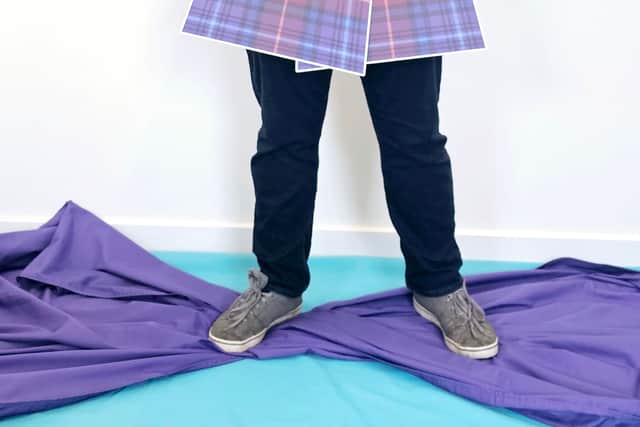 Marc Ingram, former Scottish Apprentice of the Year models a carboard kilt in the Dyslexia-Friendly Scotland tartan design.