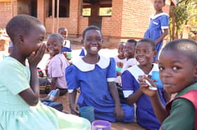 Children smiling after receiving Mary's Meals in Malawi