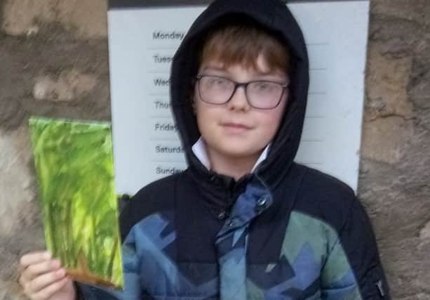 Rory aged 9 outside Bo'ness Library with one of his pictures