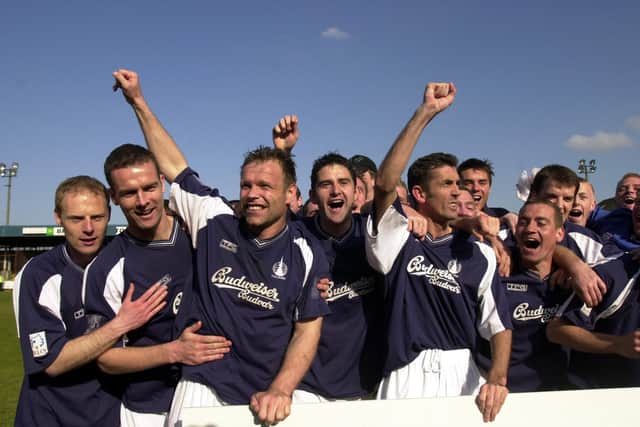 Photo: Andrew Stuart/ Falkirk (centre, l-r) John Hughes, Mark Kerr and Owen Coyle celebrate after their victory over opposition Arbroath at the Brockville Park Stadium, Falkirk; April 19, 2003. Falkirk defeated Arbroath 4 - 0 in this Fist Division decider and so win promotion to the Scottish Premier League.