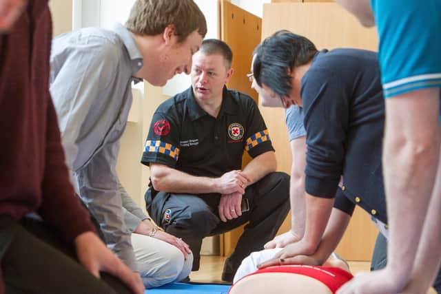 Stewart Simpson, St Andrew’s First Aid head of volunteer development, teaches life-saving CPR techniques.