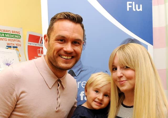River City actor Jordan Young launches the drive to boost uptake of flu vaccine, with Albert Miller-Duff (4) and his mum Alison.