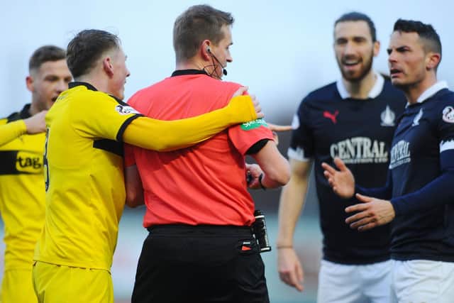 Gary Miller was lucky to stay on the pitch after bundling over the referee. Picture: Michael Gillen.