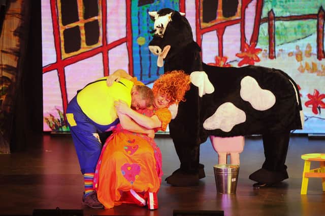 Dame Trot and Simon try to milk Daisy.  Pic: Michael Gillen.