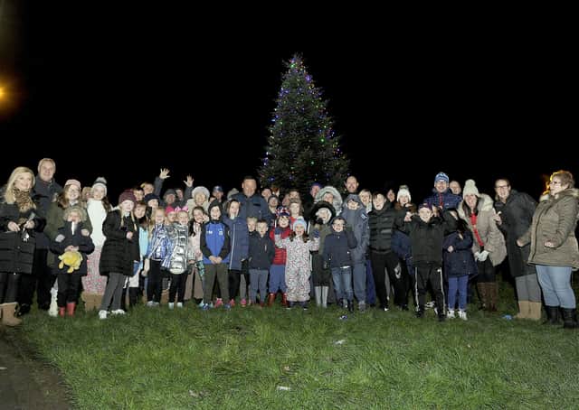 Villagers gather at the Christmas tree on Haypark Road for the switch-on ceremony. Picture: Michael Gillen