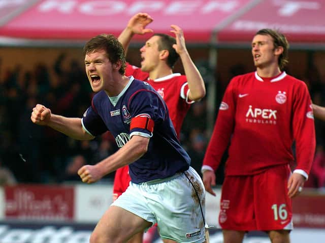 Darren Barr celebrates scoring against Aberdeen in the 2009-10 season as a familiar face looks dejected in the background.