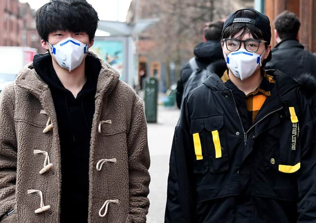 Oriental students in Glasgow - who are said to be snapping up surgical masks, although for several years they have been a common sight as Chinese and other students seek to protect themselves against the city's vehicle pollution.