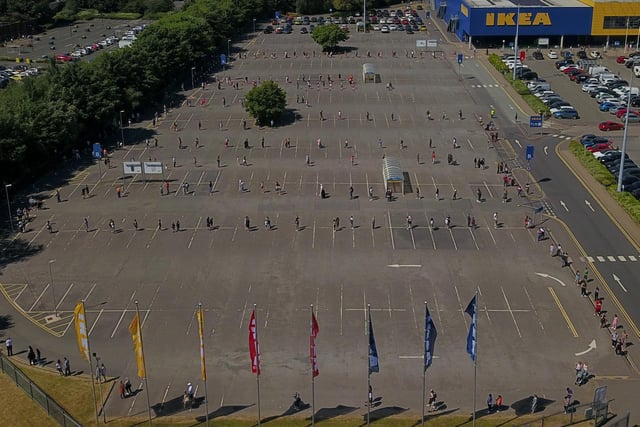 Aerial photos show hundreds of customers queuing around the block in the stifling heat to get into Ikea - as stores reopened for the first time since the coronavirus outbreak. Photos: SWNS