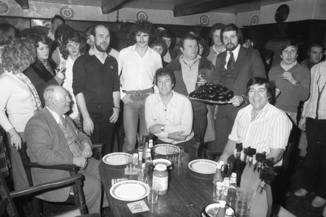 The Nelson brothers from Chorley carried off first and third prizes in the Grand Charity Black Pudding Eating contest at the Royal Oak pub, Riley Green, near Chorley. Pictured from left (front): Cyril Hardman, Roy Nelson, Eric Nelson. Standing: Ian Snape, Dave McAreavy, Joe Keany. Delivering the black puddings is Bob Collins, treasurer of the Royal Oak charity fund