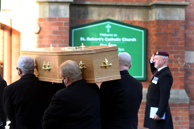 The coffin being taken into St Robert's Church