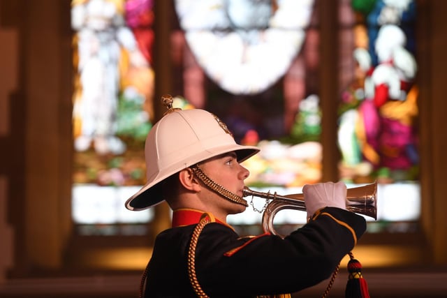 Bugler plays the last post at the end of the service at Stonefall Crematorium Chapel