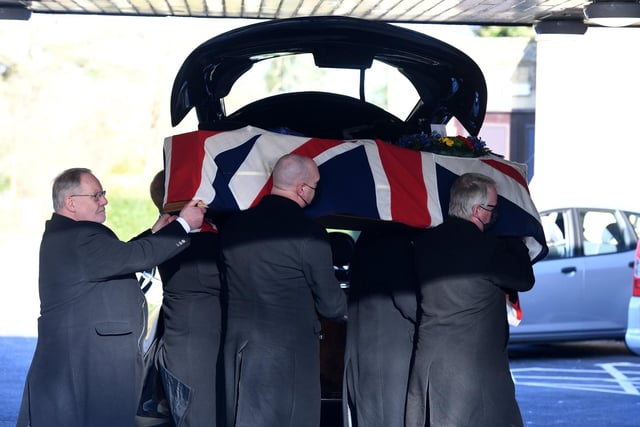 John's coffin is carried into Stonefall Crematorium Chapel
