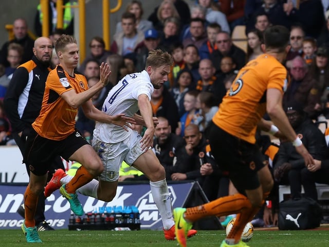 Charlie Taylor drives through the Wolves rear guard.