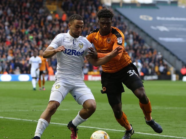 Kemar Roofe holds off a challenge.