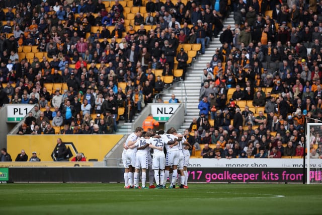 The Leeds United team in a huddle before kick-off.